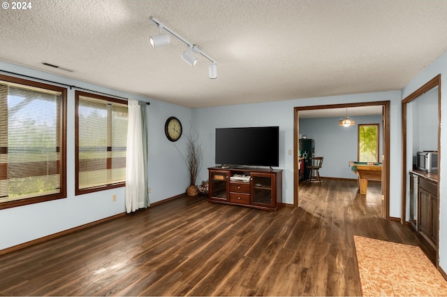 living room featuring track lighting, a textured ceiling, dark wood-type flooring, and pool table