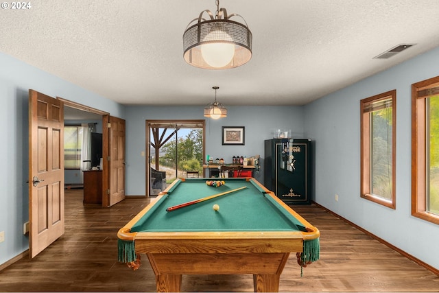 game room with a textured ceiling, dark wood-type flooring, and billiards