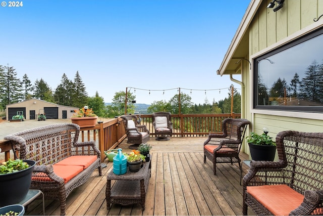 wooden terrace with an outdoor living space