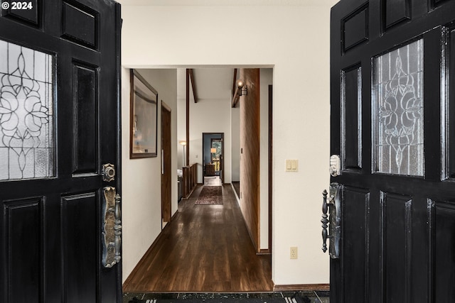 foyer entrance with beamed ceiling and dark hardwood / wood-style floors