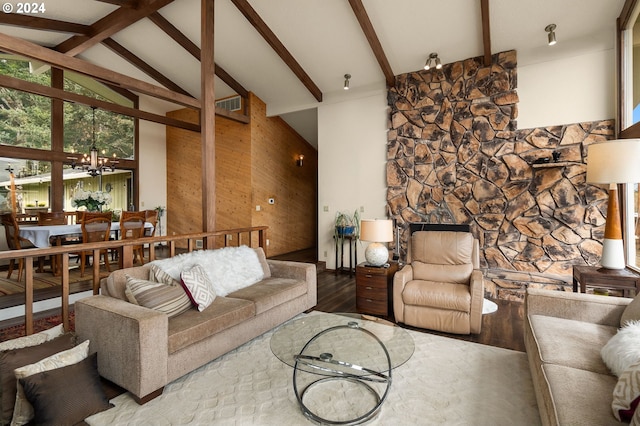 living room with a notable chandelier, hardwood / wood-style flooring, beam ceiling, and high vaulted ceiling