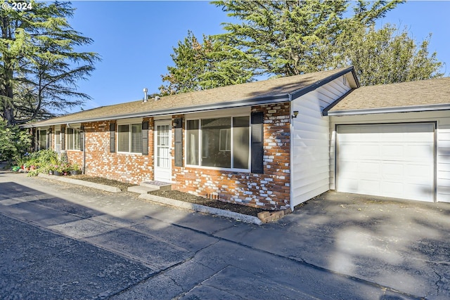 ranch-style home featuring a garage