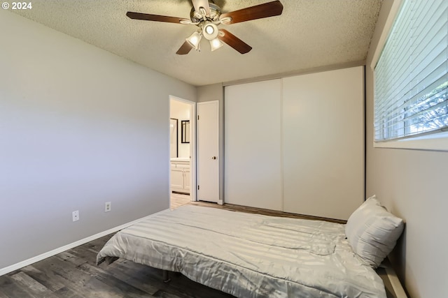 bedroom featuring a textured ceiling, hardwood / wood-style floors, connected bathroom, a closet, and ceiling fan