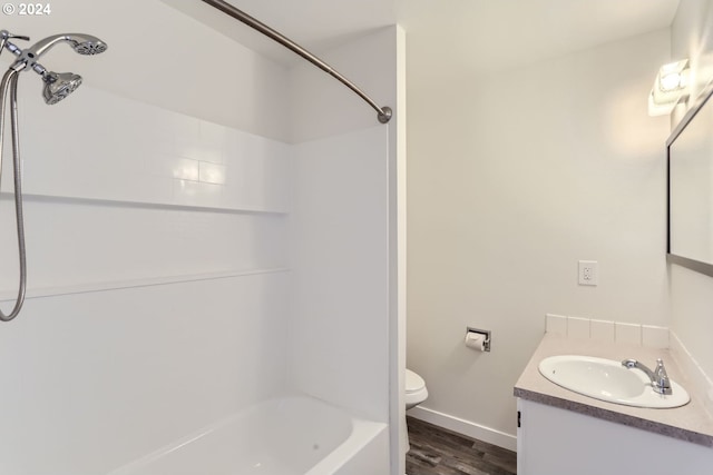 full bathroom featuring vanity, hardwood / wood-style flooring, shower / bathtub combination, and toilet