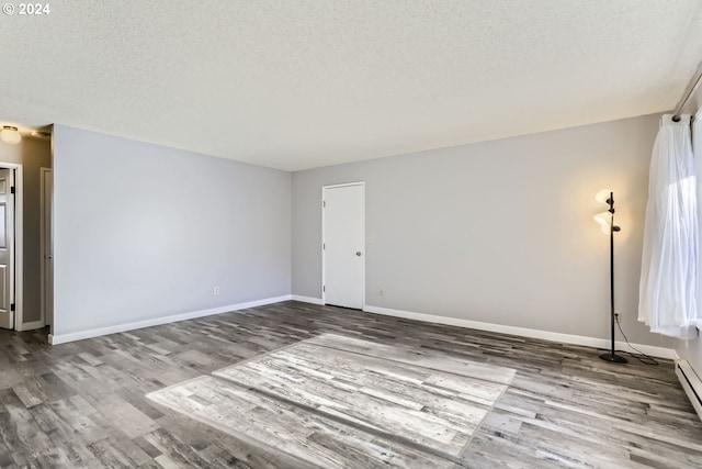 unfurnished room with light hardwood / wood-style floors and a textured ceiling