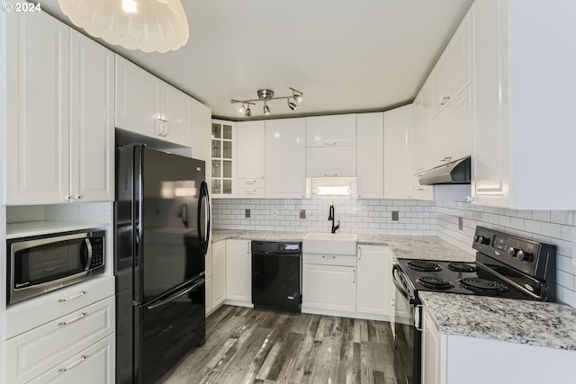 kitchen with dark wood-type flooring, white cabinets, sink, and black appliances