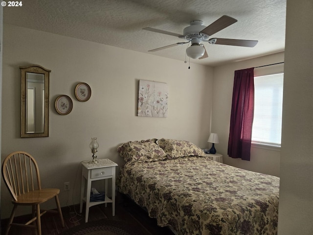 bedroom featuring a ceiling fan and a textured ceiling