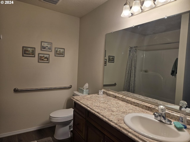 full bath featuring toilet, baseboards, wood finished floors, curtained shower, and vanity