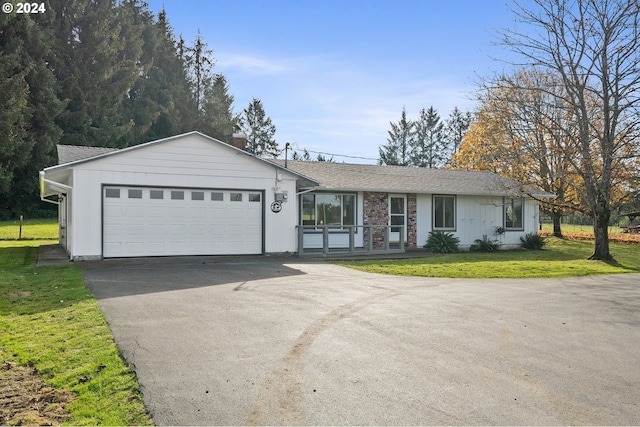 ranch-style house featuring a front yard and a garage