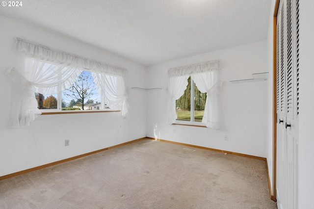 unfurnished bedroom featuring carpet flooring and a textured ceiling