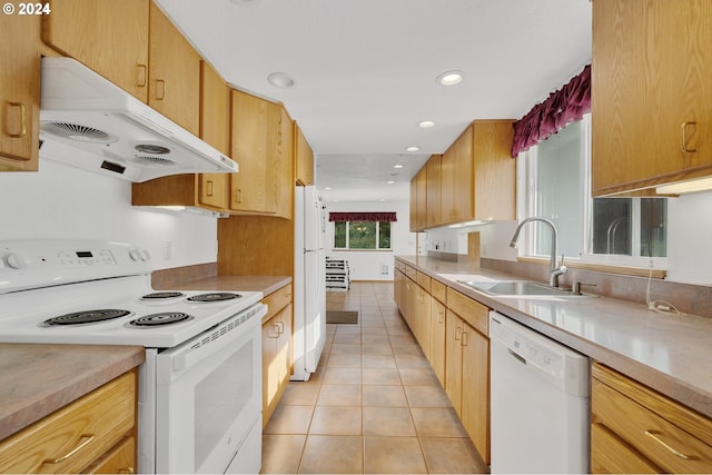 kitchen with white appliances, light tile patterned flooring, and sink