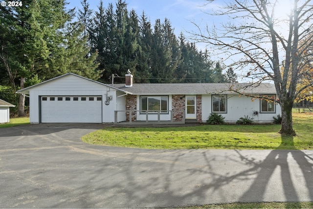 ranch-style home featuring a front lawn and a garage