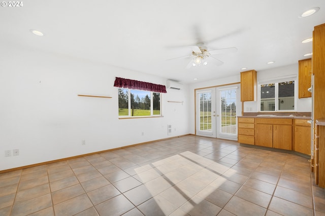 kitchen with french doors, ceiling fan, a wall mounted AC, and light tile patterned floors