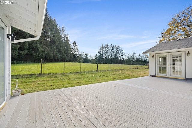 wooden terrace featuring a yard and french doors