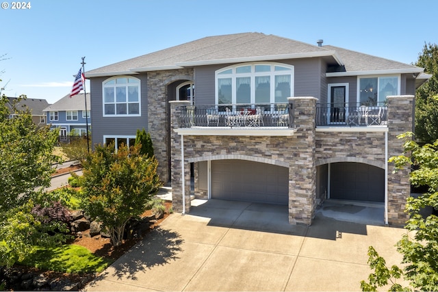 view of front of home with a garage and a balcony