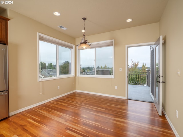 unfurnished dining area featuring hardwood / wood-style flooring