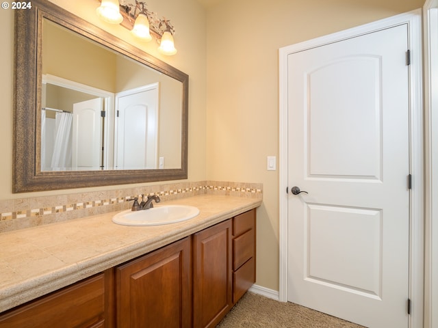 bathroom with vanity and tasteful backsplash