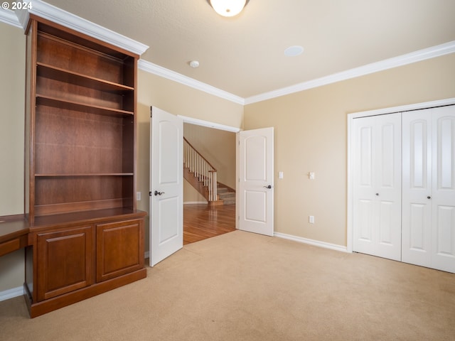 unfurnished bedroom featuring light carpet, a closet, and ornamental molding