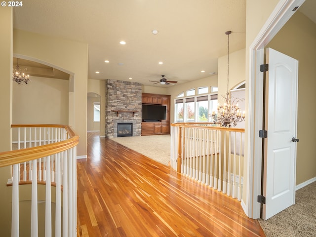 hallway featuring a chandelier and carpet flooring