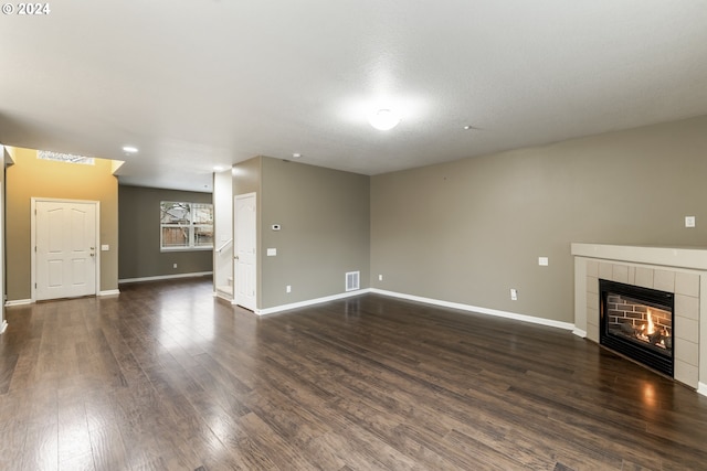 unfurnished living room featuring dark hardwood / wood-style floors and a fireplace