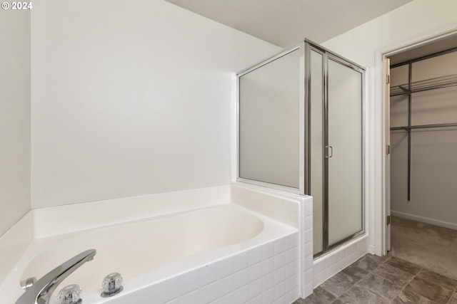 bathroom featuring separate shower and tub