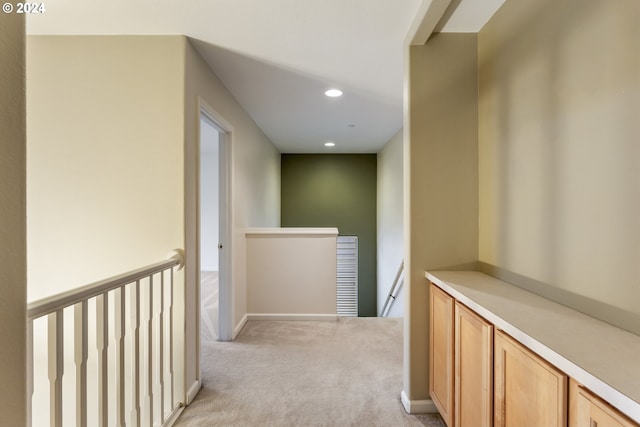 hall featuring light colored carpet