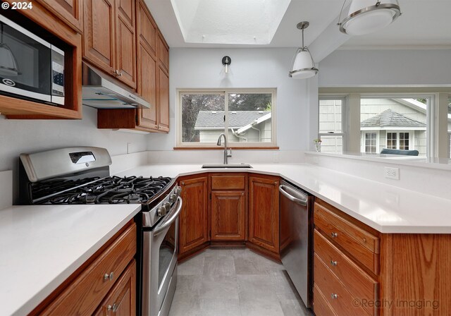 kitchen featuring decorative light fixtures, appliances with stainless steel finishes, and sink