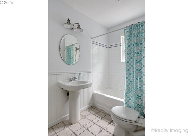 bathroom with shower / tub combo, toilet, and tile patterned floors