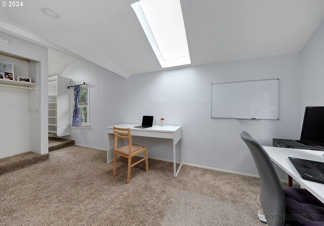 carpeted home office featuring vaulted ceiling