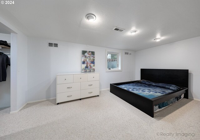 bedroom with carpet flooring and a textured ceiling