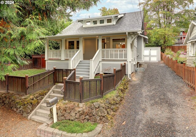 bungalow-style home with an outbuilding and a porch