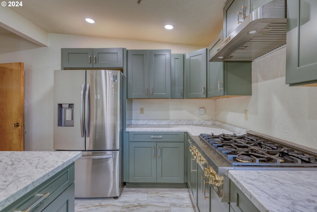 kitchen featuring recessed lighting, under cabinet range hood, marble finish floor, light stone counters, and appliances with stainless steel finishes