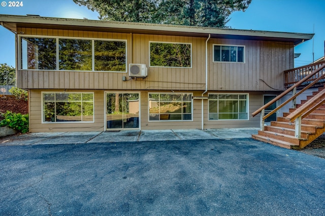 back of house with stairs and a patio