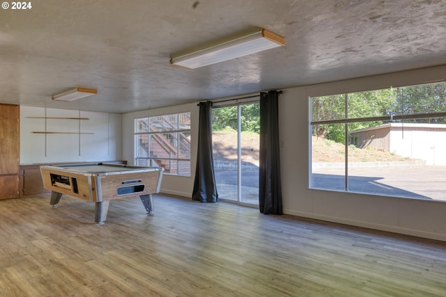 recreation room featuring billiards, baseboards, and wood finished floors
