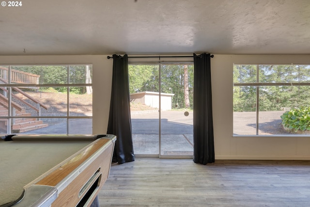 game room featuring wood finished floors, billiards, and a wealth of natural light