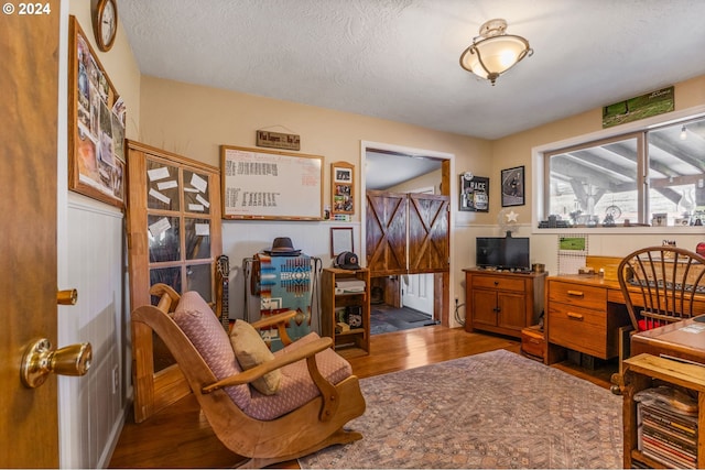 office with a textured ceiling and hardwood / wood-style flooring