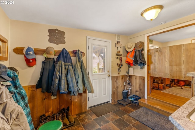 mudroom with wooden walls and dark hardwood / wood-style floors