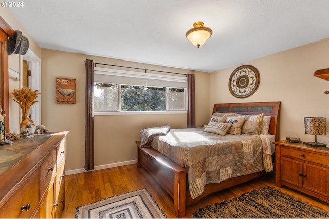 bedroom with dark hardwood / wood-style floors