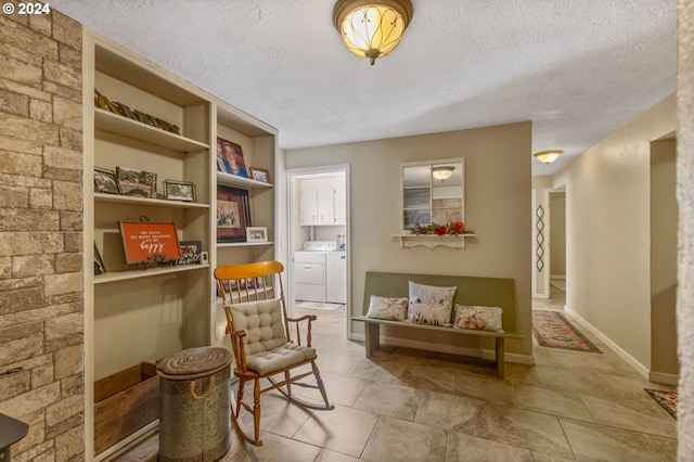 living area featuring washer and clothes dryer, a textured ceiling, and built in features