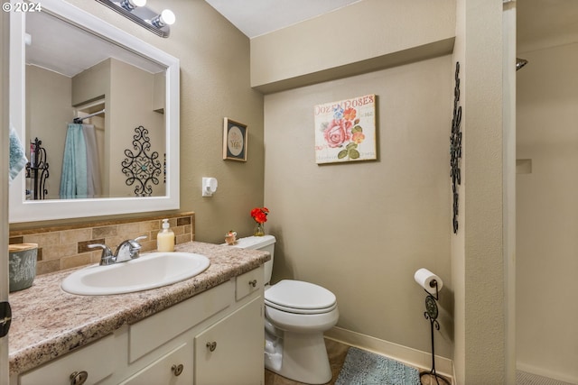 bathroom featuring walk in shower, decorative backsplash, vanity, and toilet