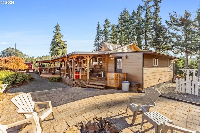 back of property with a patio and a gazebo