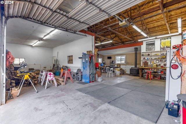 garage with a garage door opener and a workshop area