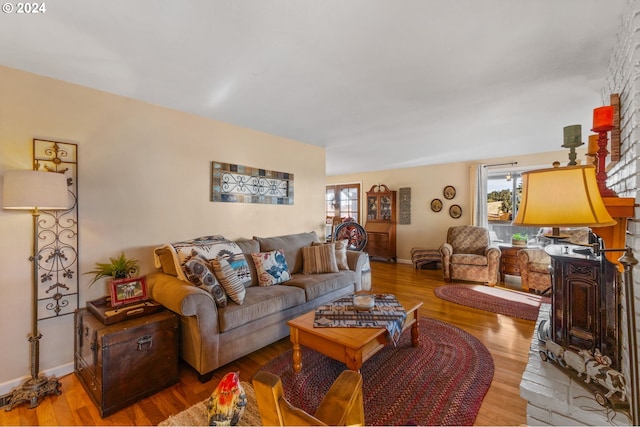 living room with light hardwood / wood-style flooring and a healthy amount of sunlight