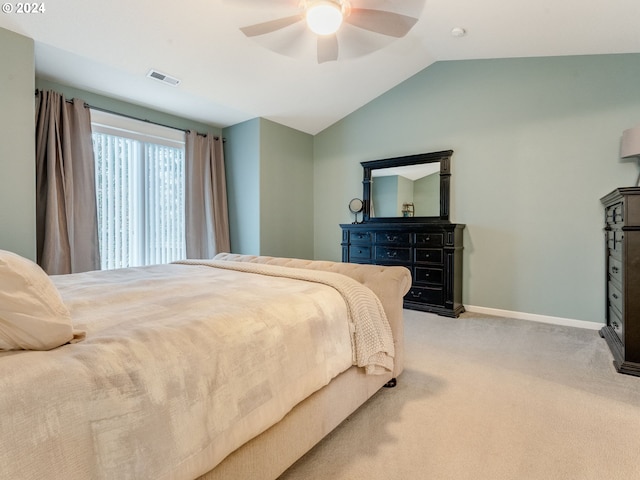 bedroom with ceiling fan, light colored carpet, and lofted ceiling