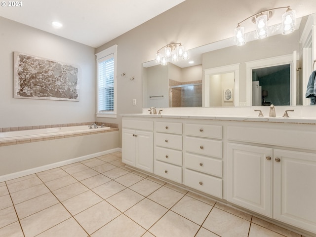 bathroom featuring tile patterned flooring, vanity, and shower with separate bathtub