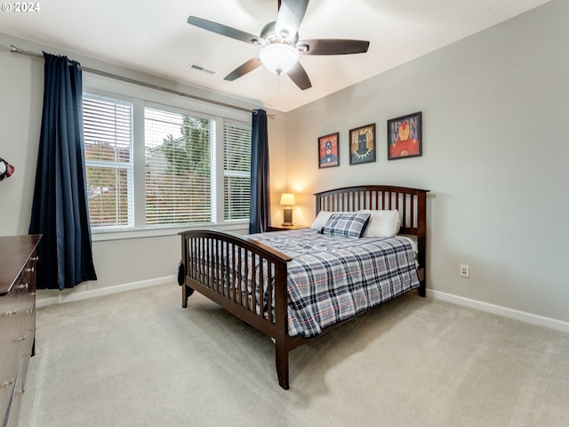 bedroom with ceiling fan and light carpet