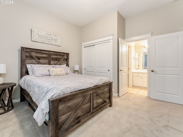 carpeted bedroom featuring ensuite bath and a closet