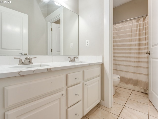 bathroom with tile patterned flooring, vanity, toilet, and a shower with shower curtain