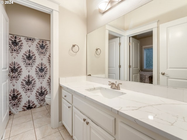 bathroom with tile patterned floors, vanity, and toilet