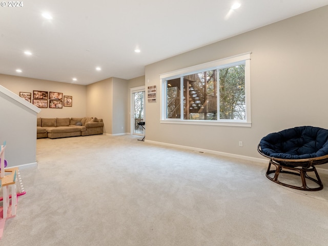 living area featuring light colored carpet